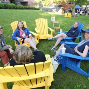 Alumni in adirondack chairs at the wine and beer garden. Photo by Ed Mailliard.