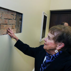 woman viewing old brick