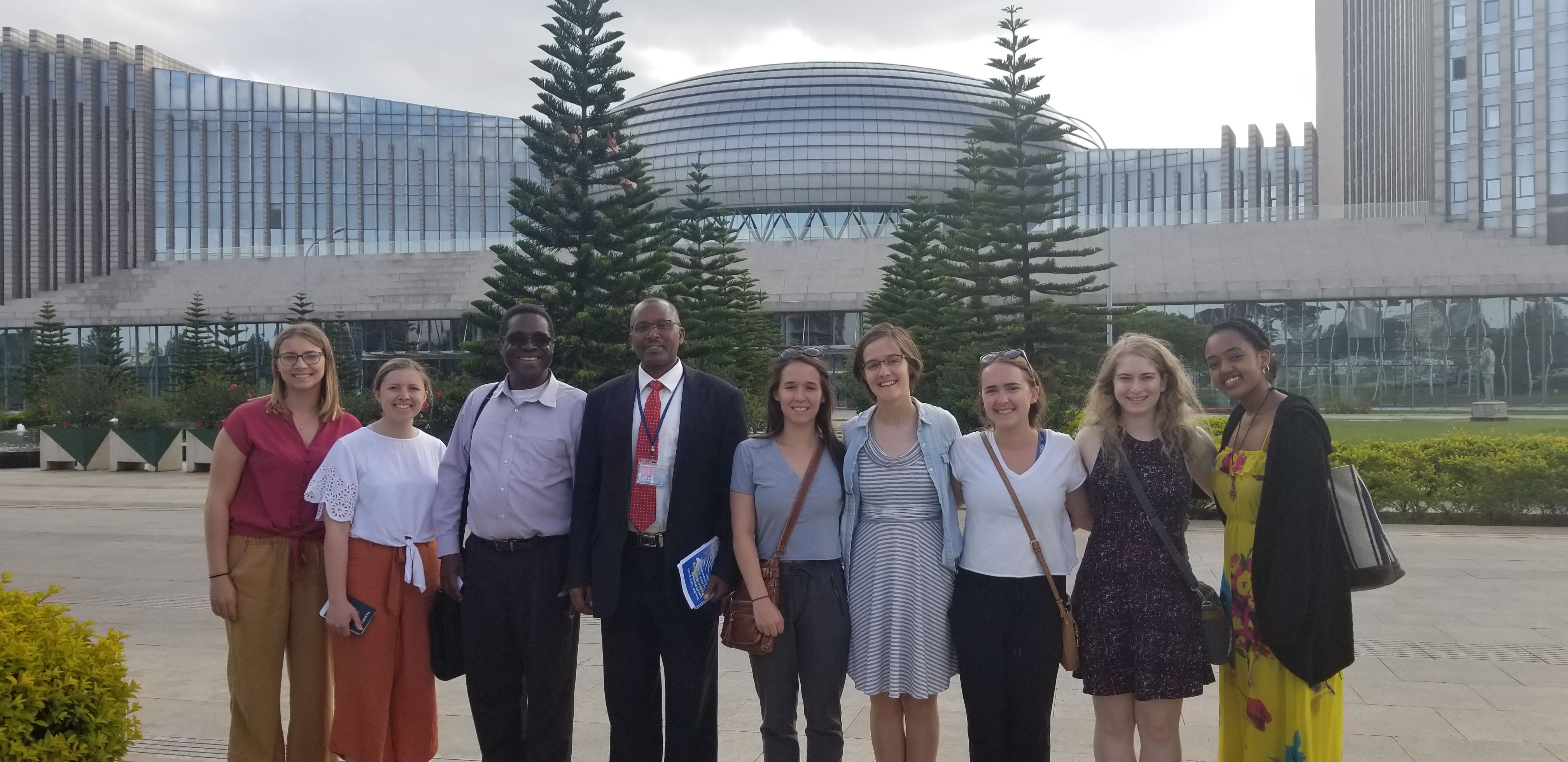 Dr. Onyeiwu with students visiting the African Union. The imposing and magnificent building in the background was donated by the Chinese government to the African Union.
