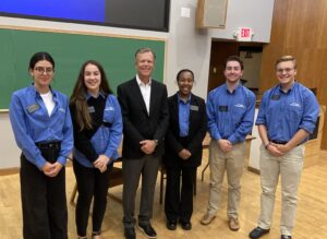 Terry Dunlap poses with students after his Lunchtime Learning Lecture entitled, "Post COVID Supply Chain Problems and it's Impact on National Security"