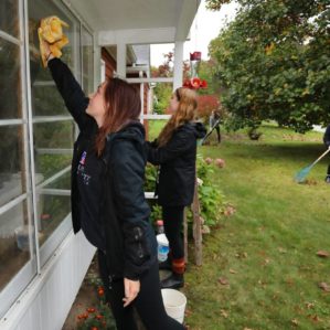 Students wash windows during Make a Difference Day