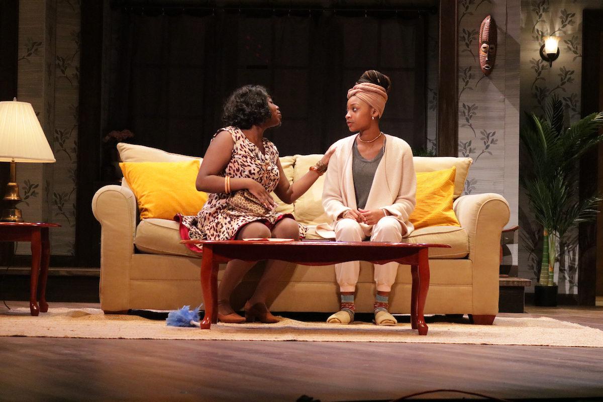 student actors talk to each other while sitting on a couch