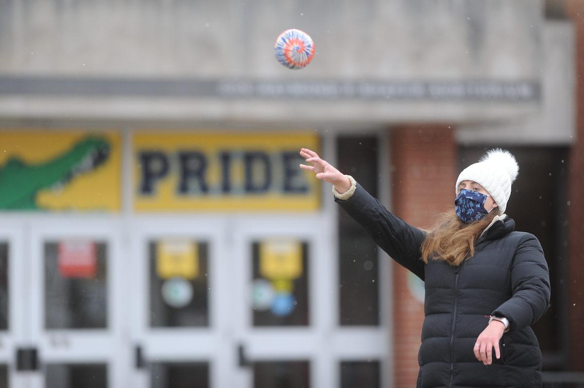 student throwing a ball