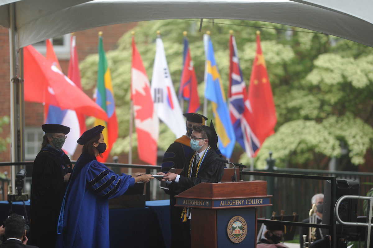 President Hilary Link presents a diploma to a graduate