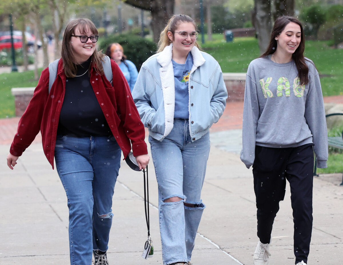 Three female students walking on campus