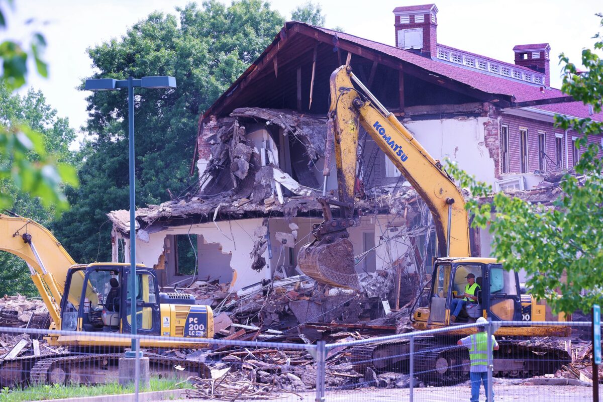 Crane destroys building