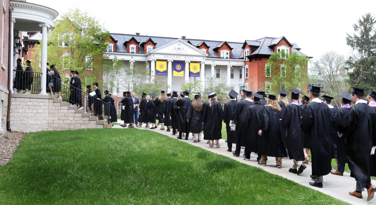 Students process through Bentley Hall during the Class of 2023's Commencement