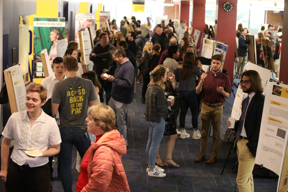 Students and visitors viewing poster presentations