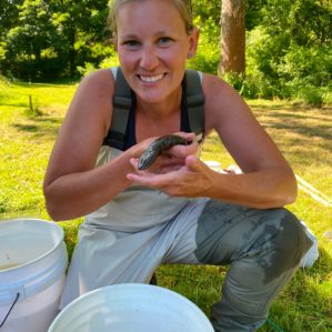 Dr. Casey Bradshaw-Wilson with a mudpuppy at one of the WCRC habitat restoration sites