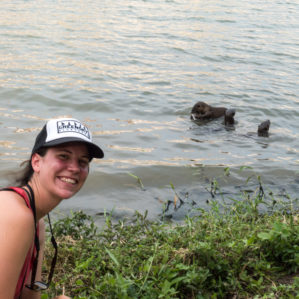 Dr. Kelly Pearce hanging out with smooth coated otters in Singapore