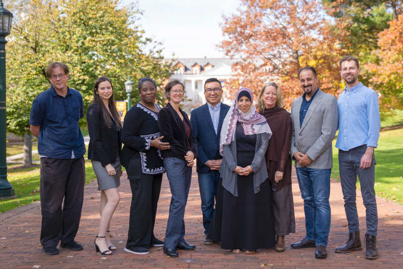 Faculty group photo of 8 faculty and staff.